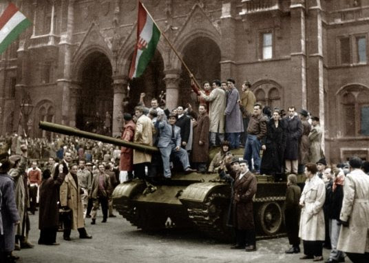 Hungarians celebrate atop an captured Soviet tank, probably a T-54